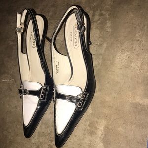 Black and white leather coach heels